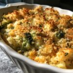 Close-up of a golden-brown Cheesy Broccoli & Cauliflower Casserole with a crispy breadcrumb topping.