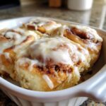 Close-up of warm Christmas Morning Cinnamon Rolls generously topped with cream cheese glaze.