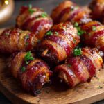 Close-up of delicious crispy bacon-wrapped dates appetizer sprinkled with parsley on a wooden board.