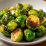 Close-up of glistening Honey-Glazed Brussels Sprouts, perfectly roasted with caramelized edges.