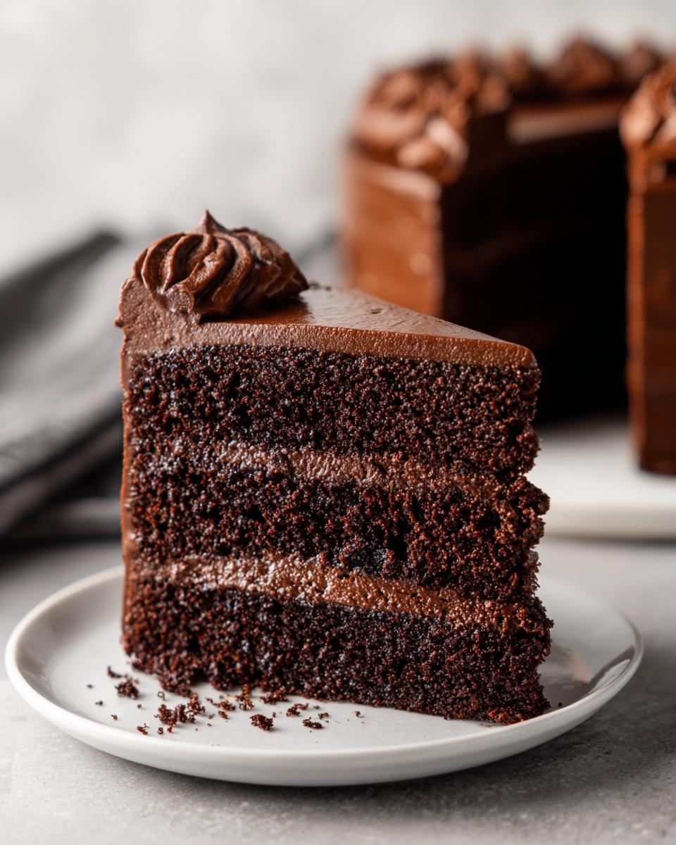 A slice of delicious Baileys Irish Cream Cake on a plate, showing layers of moist cake and frosting.