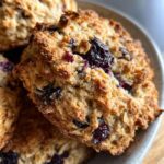 Close-up of golden-brown Blueberry Oat Biscuits, showing blueberries and oats.