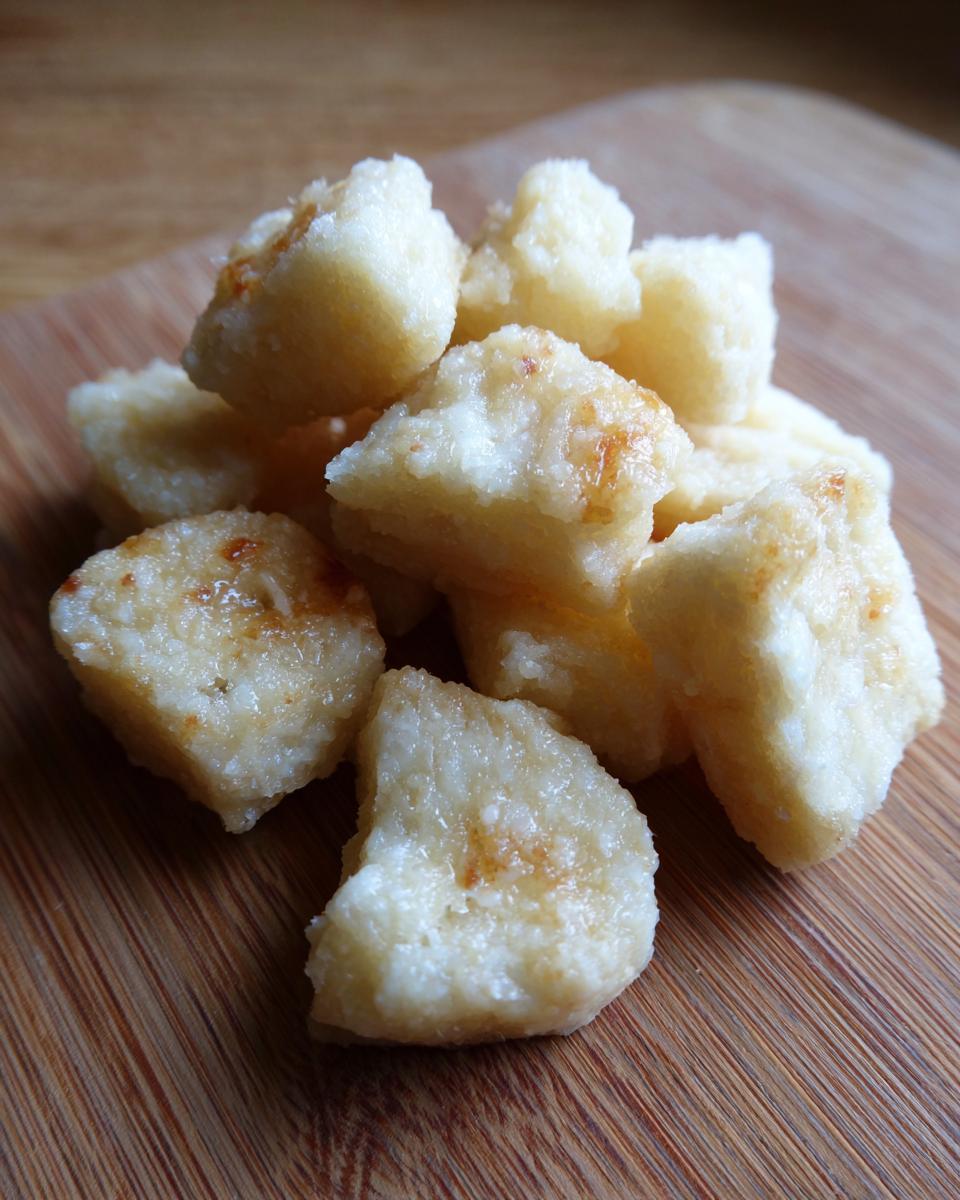 Pile of homemade Chewy Apple & Yogurt Treats on a wooden surface.