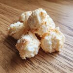 Close-up of a pile of delicious Chewy Apple & Yogurt Treats on a wooden surface.