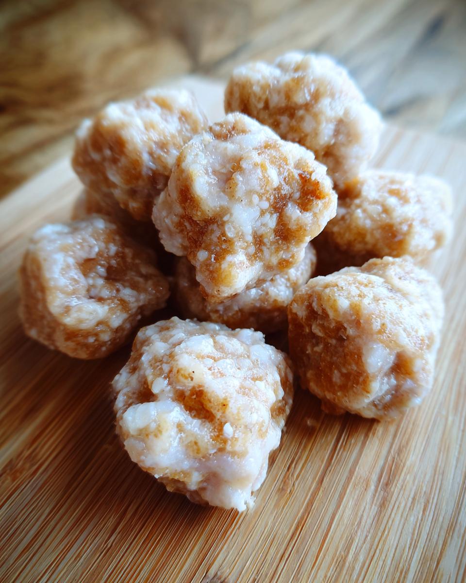 Close-up of a pile of homemade Chewy Apple & Yogurt Treats on a wooden board.