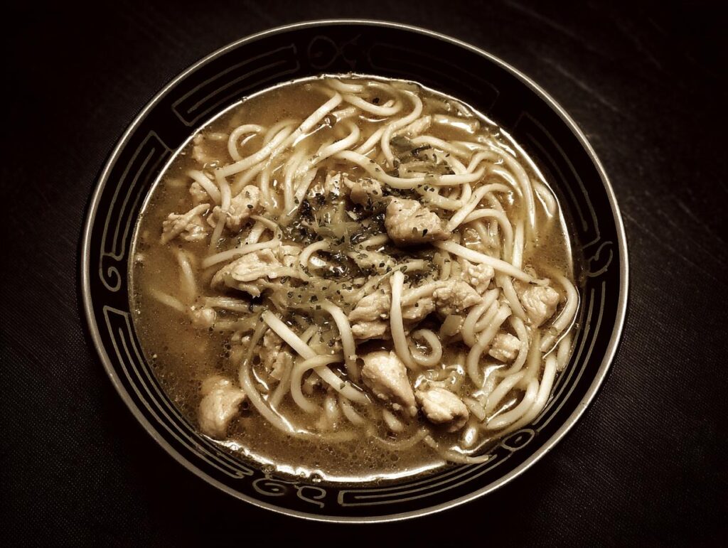 Overhead shot of a bowl of Chicken & Zoodle Spaghetti with chicken and noodles.