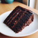 A delicious slice of Chocolate Mayonnaise Cake on a white plate, showing the moist texture.