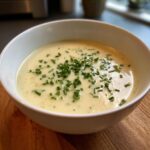 A bowl of creamy potato leek soup, garnished with chives. This Creamy Potato Leek Soup is perfect for cold evenings.