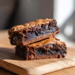 Two stacked fudgy brookies, a brownie and cookie combination, on a wooden board. The Best Fudgy Chewy Brookies!