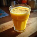 A glass of creamy Mango Lassi, a refreshing Indian drink.