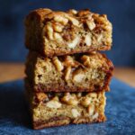 Stack of three Maple Walnut Blondies, showing the texture and walnuts.