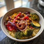 A colorful Protein-Packed Quinoa & Roasted Veggie Bowl with chickpeas, broccoli, and red onion.