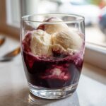 A delicious Red Wine Float with vanilla ice cream in a clear glass, ready to enjoy.