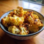 Close-up of a bowl filled with delicious Roasted Cauliflower with Warm Spices.