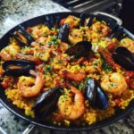 Overhead shot of a delicious Spanish Seafood Paella with shrimp, mussels, and rice.