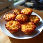 A plate of golden-brown Sweet Potato & Honey Treats muffins, baked to perfection.