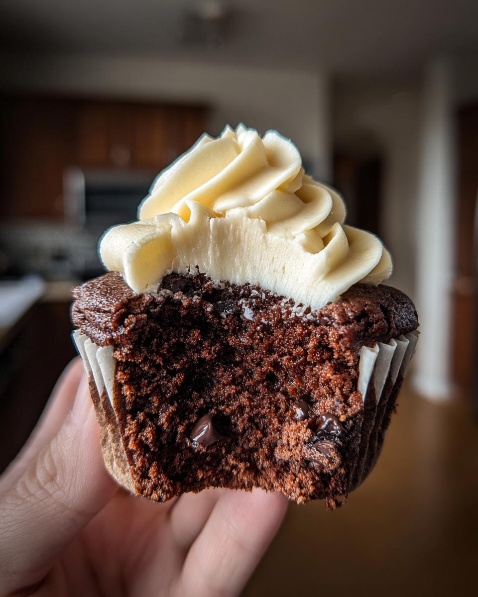 Close-up of a Chocolate Guinness Cupcake with vanilla frosting, showing the moist cake texture.