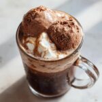 Close-up of a Guinness Chocolate Stout Float with chocolate ice cream and whipped cream.