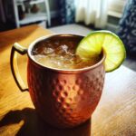 Close-up of an Irish Mule (Whiskey Moscow Mule) in a copper mug with a lime garnish.