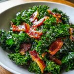 Close-up of a vibrant Kale and Bacon Salad in a white bowl, showing crispy bacon and fresh kale.