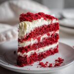 A delicious slice of 45-Minute Red Velvet Surprise Cake on a white plate, perfect for Valentine's Day.