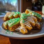 Close-up of St. Patrick's Day Animal Cracker Mix, decorated with green frosting and sprinkles.