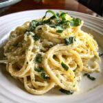A plate of delicious Lemon Ricotta Pasta topped with fresh basil and lemon zest.