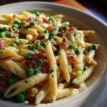 Close-up of pasta with pancetta and peas in a bowl, a delicious Pasta with Pancetta and Peas recipe.