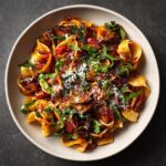Overhead shot of delicious Spring Meals Vegetable Pasta with fresh veggies, basil, and parmesan cheese.