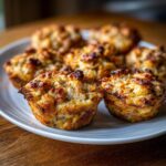 Close-up of a plate of Baked Chicken and Carrot Dog Muffins, golden brown and delicious.