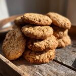 Stack of homemade Banana Oat Healthy Dog Cookies on a wooden tray.