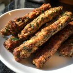 Close-up of homemade Beef and Parsley Fresh Breath Chew Sticks on a white plate.