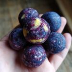 Hand holding a pile of Blueberry Banana Frozen Dog Smoothie Bites.
