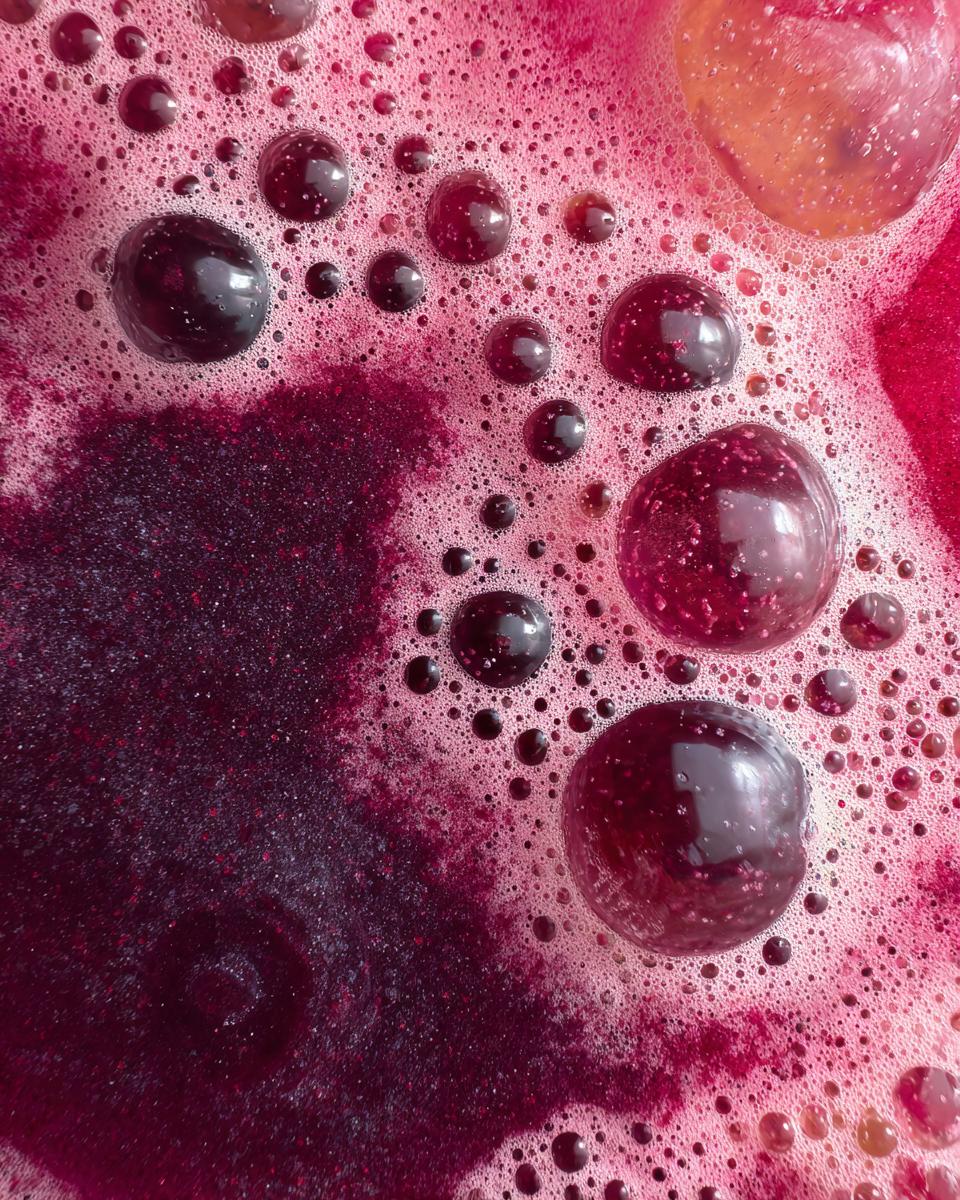 Close-up of a bubbly Blueberry Banana Homemade Pup Smoothie Treat.
