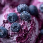 Close-up of Blueberry Plain Yogurt Frozen Dog Bite Drops with fresh blueberries.