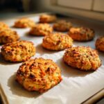 Close-up of freshly baked Carrot Cake Dog Treat Cookies on parchment paper.