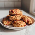 Pile of homemade Strawberry Banana Oat Dog Treats on a white plate, ready for your pup to enjoy.