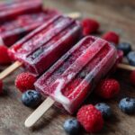 Close-up of frozen yogurt berry dog treats with raspberries and blueberries, a perfect Easy Yogurt Berry Frozen Dog Treats recipe.