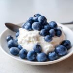 Close-up of Yogurt Blueberry Frozen Dog Drops topped with fresh blueberries, a healthy treat.